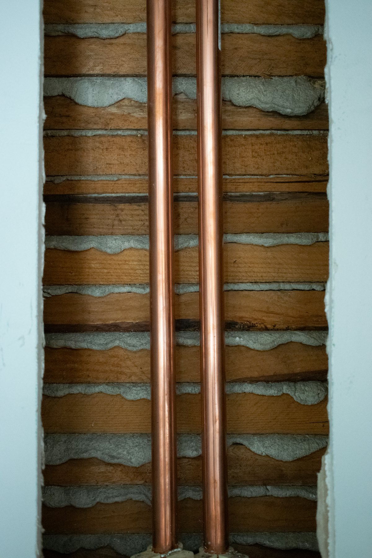 New copper water lines run through an opened wall